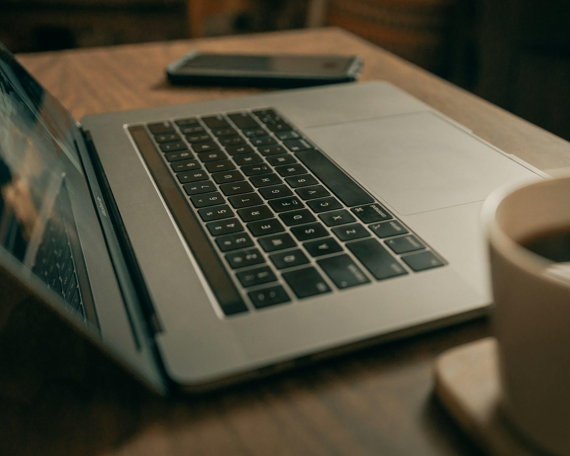 A Macbook Pro on brown wooden table by Clay Banks via UnSplash.com